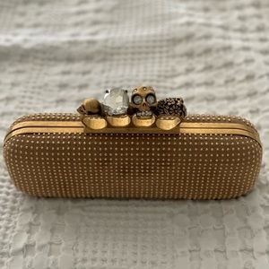Alexander McQueen gold knuckle clutch.